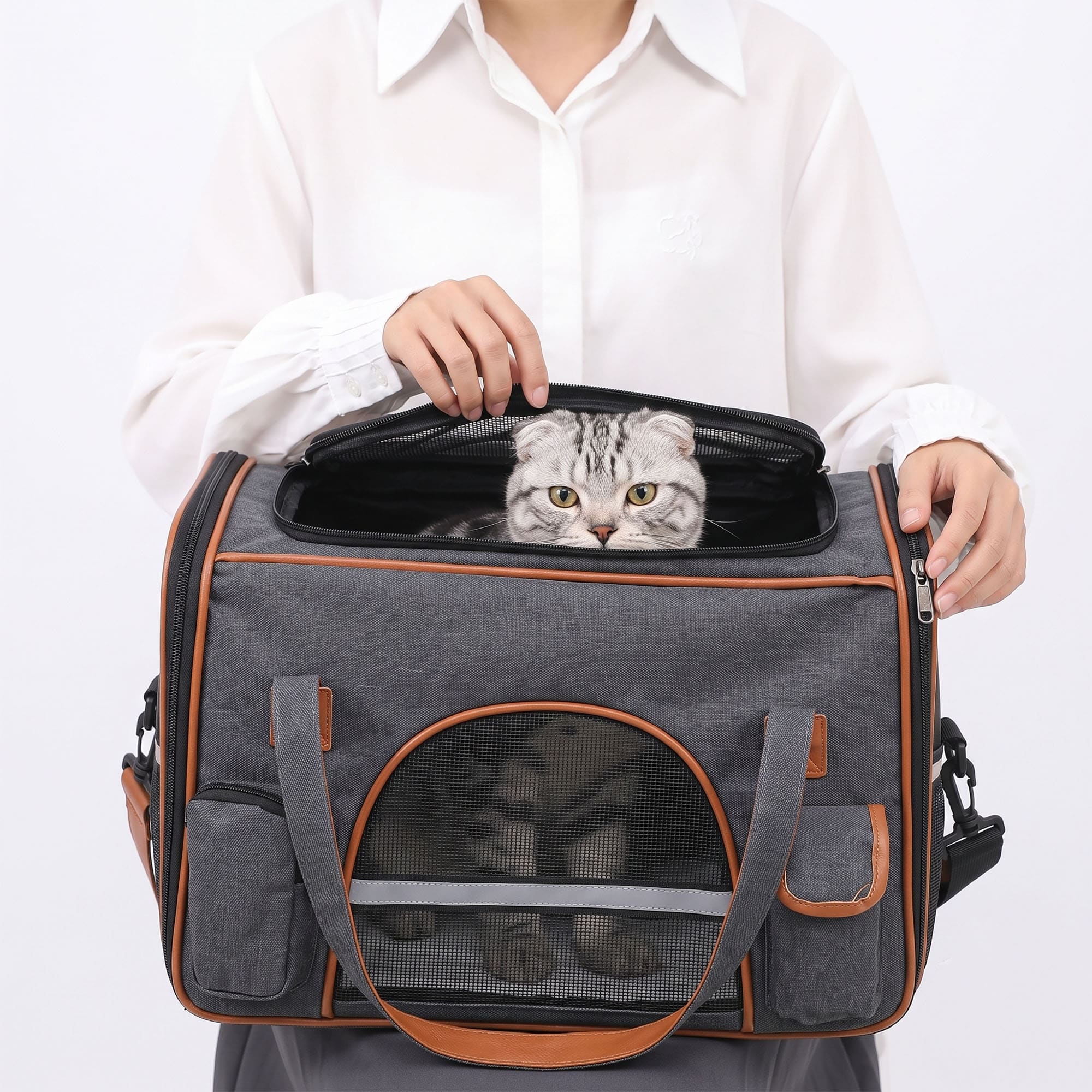 Cat looking out from top opening of gray breathable pet carrier tote