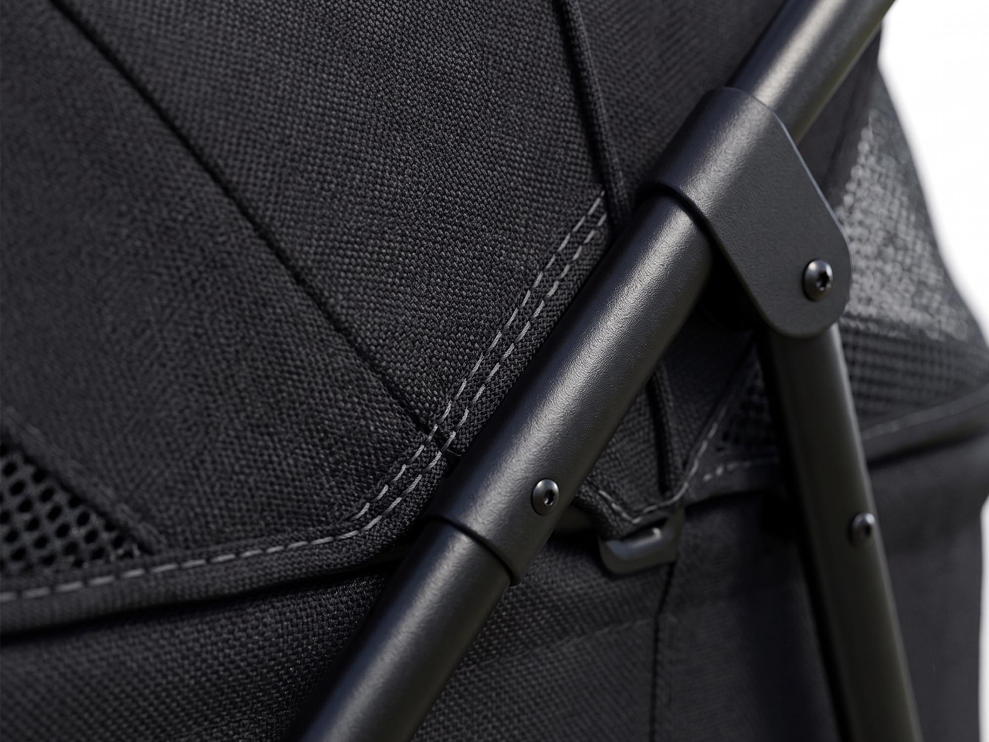 A detailed close-up shot highlighting the high-quality construction of the pet stroller, featuring durable, thickened black Oxford fabric with reinforced double stitching and a sturdy matte black metal frame joint secured with screws.
