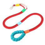 Red nylon dog leash with foam handle, silicone slider rings, and alloy clasp