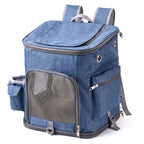 Blue pet carrier backpack with front mesh door, side pockets, and top opening