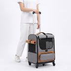 Person pulling gray wheeled pet carrier with telescoping luggage handle
