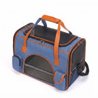 Blue breathable pet carrier tote with mesh windows and side storage pockets