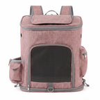 Pink pet carrier backpack with front mesh door, side pockets, and top opening