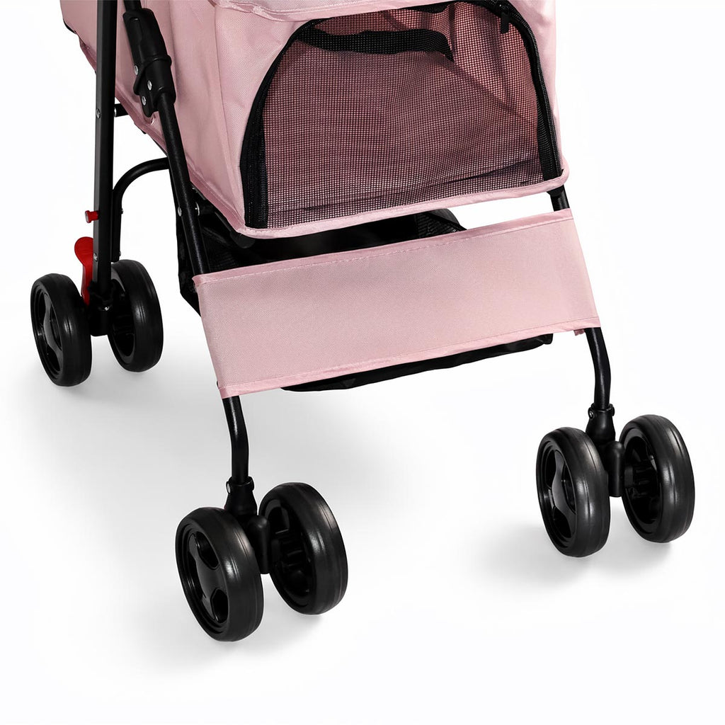 Close-up of pink pet stroller cabin and four-wheel frame