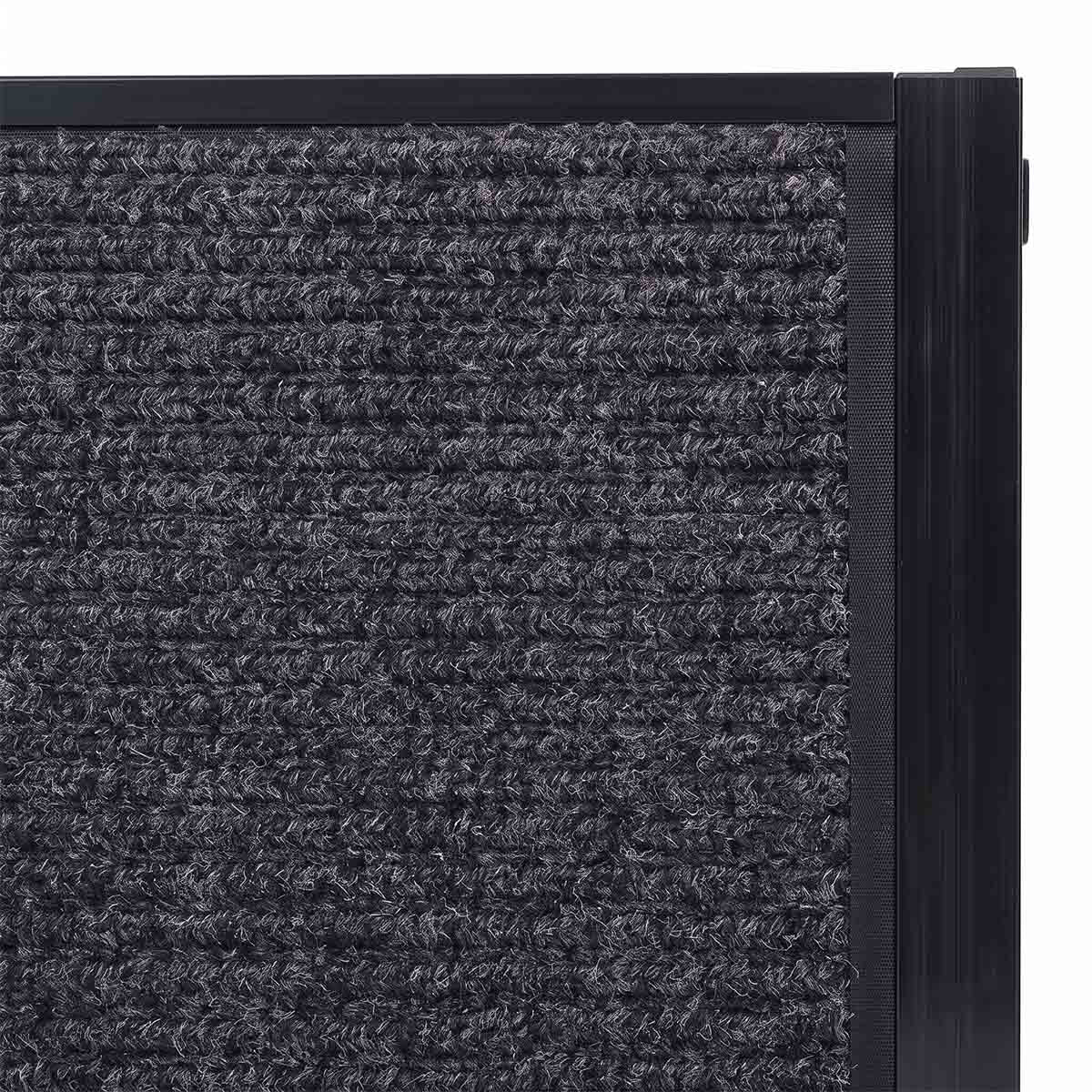 Close-up of textured carpet surface on black dog car ramp