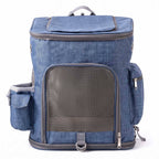 Blue pet carrier backpack with front mesh door, side pockets, and top opening