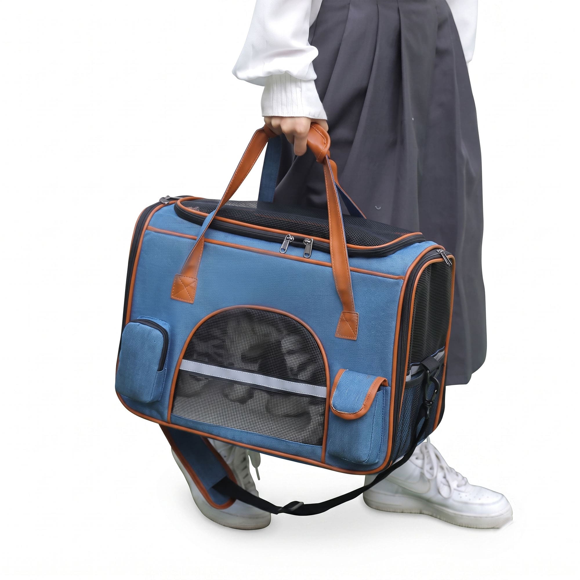 Blue pet carrier tote carried by hand with mesh window and shoulder strap