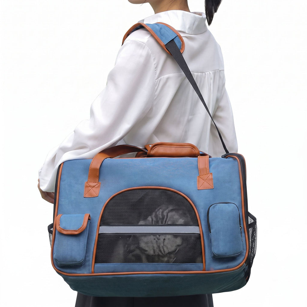 Blue pet carrier tote worn with shoulder strap for cat travel