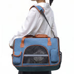 Blue pet carrier tote worn with shoulder strap for cat travel
